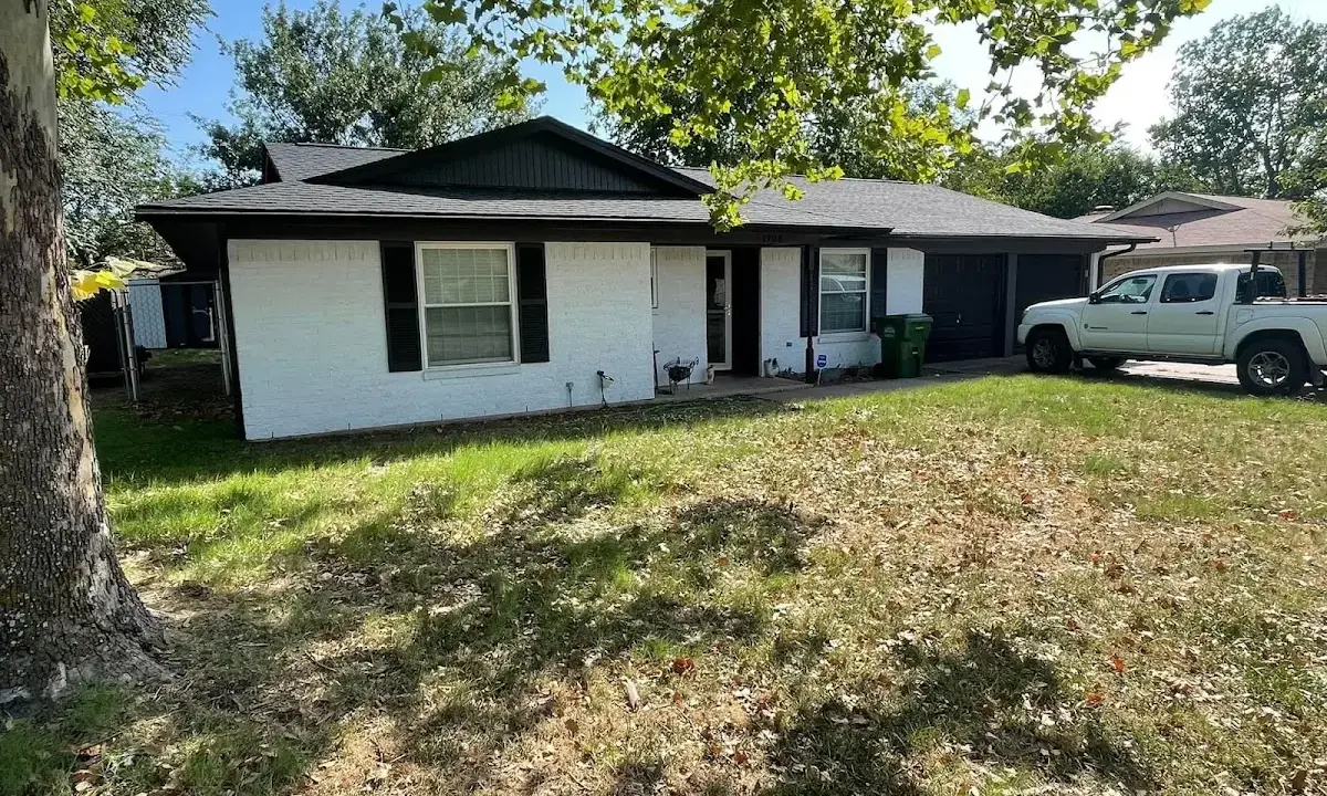 Professional roofing crew working on a residential roof in Town and Country